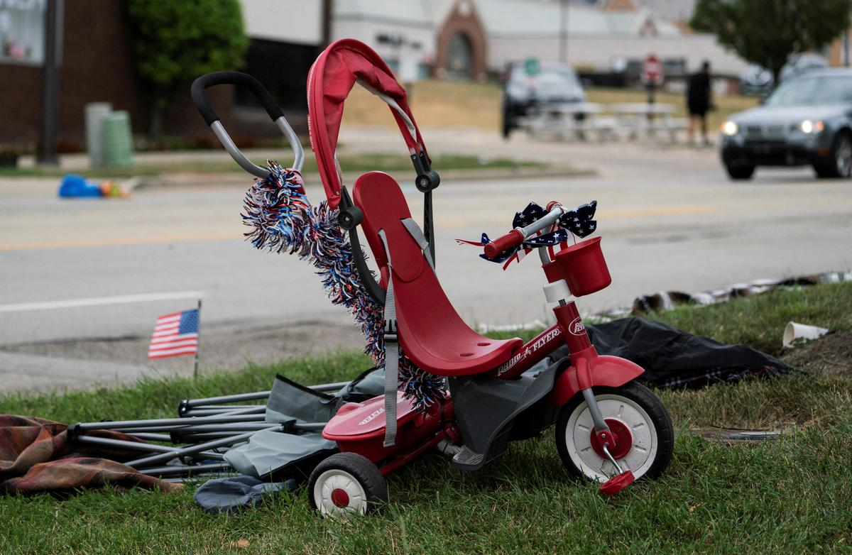 A tricycle is seen near the scene of a mass shooting at a Fourth of July parade route in the wealthy Chicago suburb of Highland Park, Illinois, U. S. | Photo Credit: Reuters